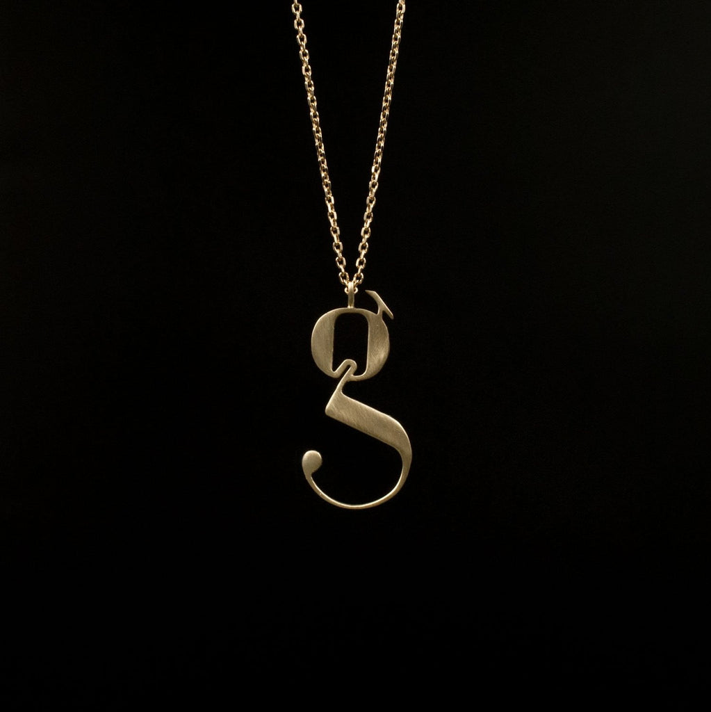 Gold Lowercase g necklace Designed by Moshik Nadav Typography with Paris Pro Typeface