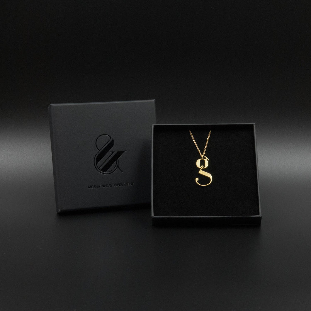 Gold Lowercase g necklace Designed by Moshik Nadav Typography with Paris Pro Typeface