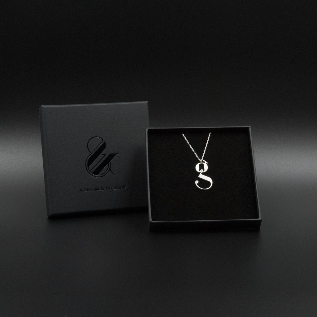 Silver Lowercase g necklace Designed by Moshik Nadav Typography with Paris Pro Typeface
