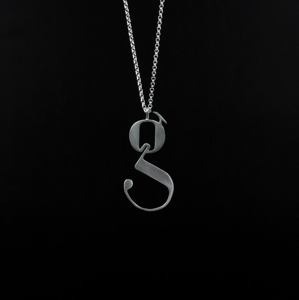 Silver Lowercase g necklace Designed by Moshik Nadav Typography with Paris Pro Typeface