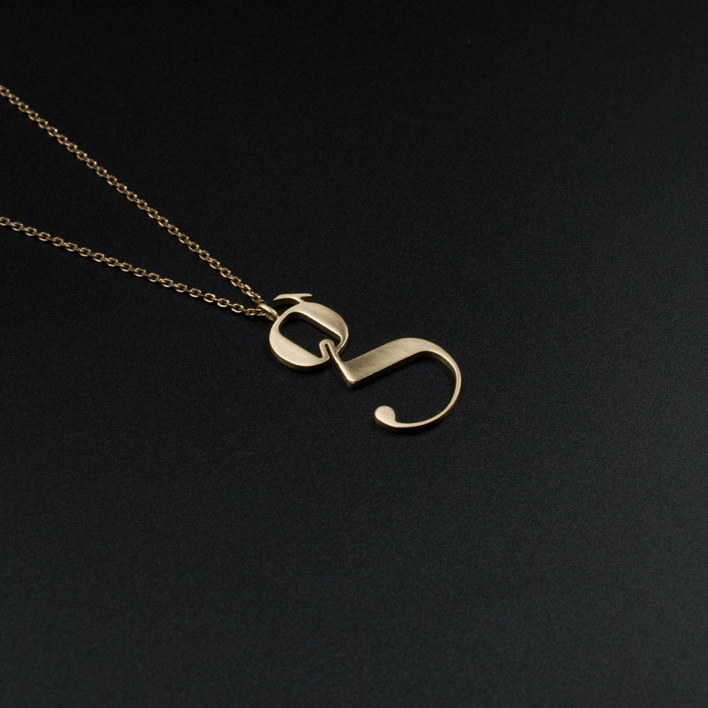 Gold Lowercase g necklace Designed by Moshik Nadav Typography with Paris Pro Typeface